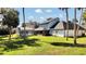 Expansive backyard featuring a screened pool and covered patio area at 2305 Leeward Cv, Kissimmee, FL 34746