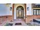 Elegant front door with decorative glass, brick accents, and stylish wall sconces at 2305 Leeward Cv, Kissimmee, FL 34746