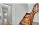 Hallway with wood stairs and a light blue wainscotted wall at 2305 Leeward Cv, Kissimmee, FL 34746