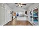 Wide view of kitchen area that shows white cabinetry and granite countertops, brick oven area, and french doors at 2305 Leeward Cv, Kissimmee, FL 34746