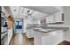 Kitchen boasting granite countertops, white cabinets, brick oven area, and stainless refrigerator at 2305 Leeward Cv, Kissimmee, FL 34746