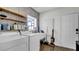 This laundry room boasts floating shelves, chevron accent wall, and modern appliances at 2305 Leeward Cv, Kissimmee, FL 34746