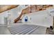 Open living space with a wooden staircase, tiled floors, and natural light at 2305 Leeward Cv, Kissimmee, FL 34746