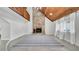 Cozy living room featuring a stone fireplace, wood ceilings and second story balcony at 2305 Leeward Cv, Kissimmee, FL 34746