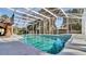 Inviting screened-in pool with tile accents and ample space for lounging at 2305 Leeward Cv, Kissimmee, FL 34746