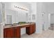 Double vanity bathroom with dark wood cabinets at 24728 Calusa Blvd, Eustis, FL 32736