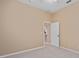 Bedroom with door to bathroom and ceiling fan at 24728 Calusa Blvd, Eustis, FL 32736