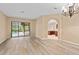 Spacious dining room featuring wood-look flooring, and views of the pool and kitchen at 24728 Calusa Blvd, Eustis, FL 32736