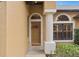 Inviting entryway with a decorative wreath and arched window at 24728 Calusa Blvd, Eustis, FL 32736