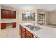 Kitchen features a breakfast bar, double sink, and view of the backyard at 24728 Calusa Blvd, Eustis, FL 32736