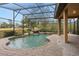 This screened pool and spa features a waterfall at 24728 Calusa Blvd, Eustis, FL 32736