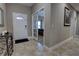 Light and airy entryway with tile floors, a console table, and access to a bedroom at 2518 Hayden Valley St, Apopka, FL 32703