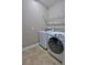 Bright laundry room with Samsung washer and dryer, and ample shelving at 2518 Hayden Valley St, Apopka, FL 32703