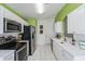 Modern kitchen with white cabinets, stainless steel appliances, and white quartz countertops at 255 Autumn Ridge Rd, Deltona, FL 32725