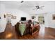 Living room with dark brown sectional sofa, wood flooring, and a view of the backyard at 255 Autumn Ridge Rd, Deltona, FL 32725