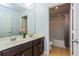 Bathroom featuring a double sink vanity next to a door leading to a toilet and tub/shower at 2570 Marshfield Preserve Way, Kissimmee, FL 34746