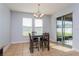 Bright dining area with large windows and sliding glass door to the patio at 2570 Marshfield Preserve Way, Kissimmee, FL 34746