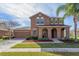 Charming two-story home with well-manicured lawn and arched front porch at 2570 Marshfield Preserve Way, Kissimmee, FL 34746