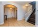 Welcoming foyer with tile flooring, arched doorway, and staircase to the second floor at 2570 Marshfield Preserve Way, Kissimmee, FL 34746