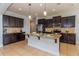 Spacious kitchen featuring dark cabinetry, granite countertops, and stainless steel appliances at 2570 Marshfield Preserve Way, Kissimmee, FL 34746