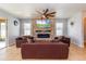 Cozy living room features a stone accent wall with fireplace and neutral furniture at 2570 Marshfield Preserve Way, Kissimmee, FL 34746