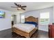 Spacious main bedroom featuring wood floors, a ceiling fan, and bright natural light at 2570 Marshfield Preserve Way, Kissimmee, FL 34746