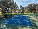 Well maintained community tennis court surrounded by mature trees and green space at 2570 Marshfield Preserve Way, Kissimmee, FL 34746