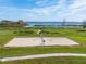 Community sand volleyball court for recreational fun with lake view and green surroundings at 2570 Marshfield Preserve Way, Kissimmee, FL 34746