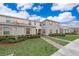 Tan two-story townhome with landscaped grounds at 2873 Sunstone Dr, Kissimmee, FL 34758