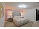 Main bedroom with a tall gray headboard, Parisian bedding, and two nightstands at 2952 Protagonist St, Kissimmee, FL 34746