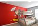 Mickey Mouse wall art and bunk bed in a red and gray bedroom at 2952 Protagonist St, Kissimmee, FL 34746