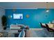 Living room with teal walls, TV, and comfortable seating at 2952 Protagonist St, Kissimmee, FL 34746