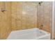 Clean bathroom with tan tile and a white bathtub at 3002 Clubview Dr, Orlando, FL 32822