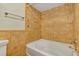 Clean bathroom with tan tile and a white bathtub at 3002 Clubview Dr, Orlando, FL 32822