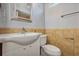 Small bathroom with white sink and toilet, tan tile at 3002 Clubview Dr, Orlando, FL 32822