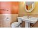 Small bathroom with pedestal sink, toilet and tiled walls at 3002 Clubview Dr, Orlando, FL 32822