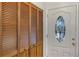 Interior entryway showcasing a white door with a stained-glass window and wooden closet at 3002 Clubview Dr, Orlando, FL 32822