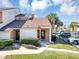 Front view of a townhome featuring a brown roof and neatly manicured lawn at 3002 Clubview Dr, Orlando, FL 32822