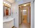 Well-lit bathroom with a sink, mirror, and tile flooring at 3002 Clubview Dr, Orlando, FL 32822