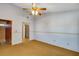 Spacious bedroom featuring a ceiling fan and neutral carpeting at 3002 Clubview Dr, Orlando, FL 32822