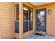 Close-up of the front door with decorative glass and surrounding sidelight windows adding natural light at 3002 Clubview Dr, Orlando, FL 32822