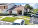 Charming townhome featuring well-maintained landscaping and a designated parking spot in a quiet community at 3002 Clubview Dr, Orlando, FL 32822