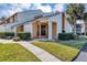 Charming townhome featuring a well-manicured lawn, walkway and a inviting front entrance at 3002 Clubview Dr, Orlando, FL 32822