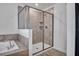 Bathroom featuring a glass shower enclosure, tiled walls, and modern shower head at 3012 Penelope Loop, Kissimmee, FL 34746