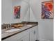 Modern bathroom featuring double sinks, gray countertops, white cabinetry, and decorative wall art at 3012 Penelope Loop, Kissimmee, FL 34746