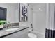 Modern bathroom featuring a shower over the tub, white subway tiles, and updated fixtures at 3012 Penelope Loop, Kissimmee, FL 34746