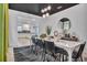 Dining room features a white table, views of the kitchen and unique modern lighting at 3012 Penelope Loop, Kissimmee, FL 34746