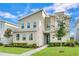 Contemporary two-story home with stone accents, manicured lawn, and inviting blue front door at 3012 Penelope Loop, Kissimmee, FL 34746