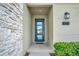 Close-up of the blue-framed front door with glass inserts and modern house number at 3012 Penelope Loop, Kissimmee, FL 34746