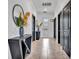 Inviting hallway featuring dark doors, ceramic tile floor, decorative table, and modern mirror at 3012 Penelope Loop, Kissimmee, FL 34746